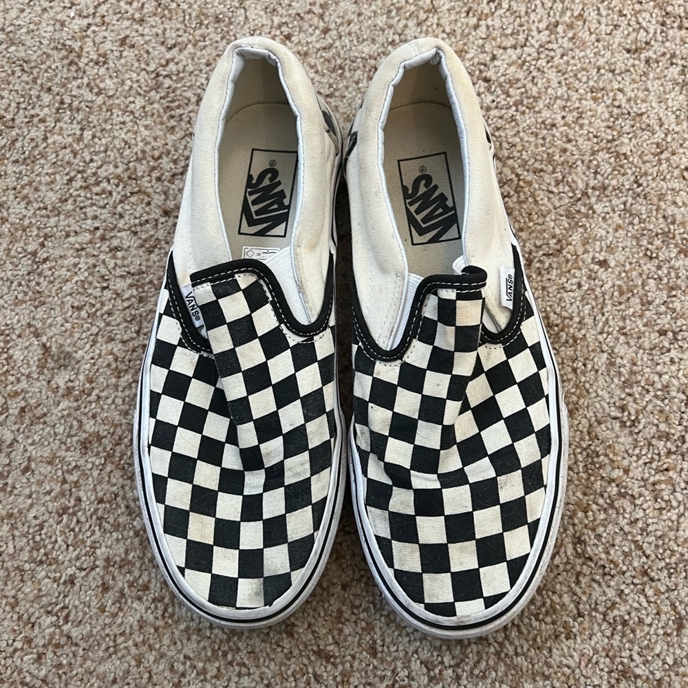 Checkerboard slip on vans in black